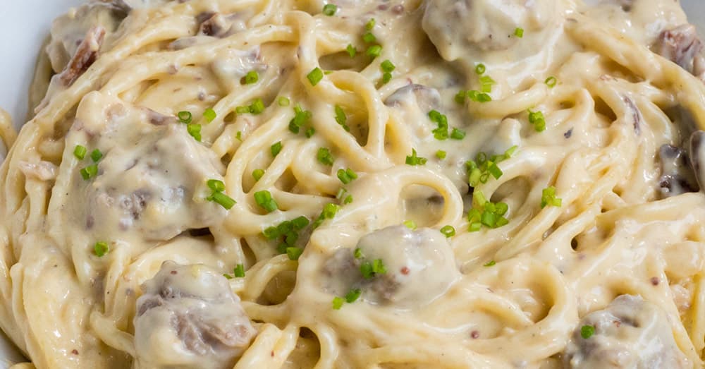 German Spaghetti with Bratwurst, Bacon, and Creamy Cheddar Sauce